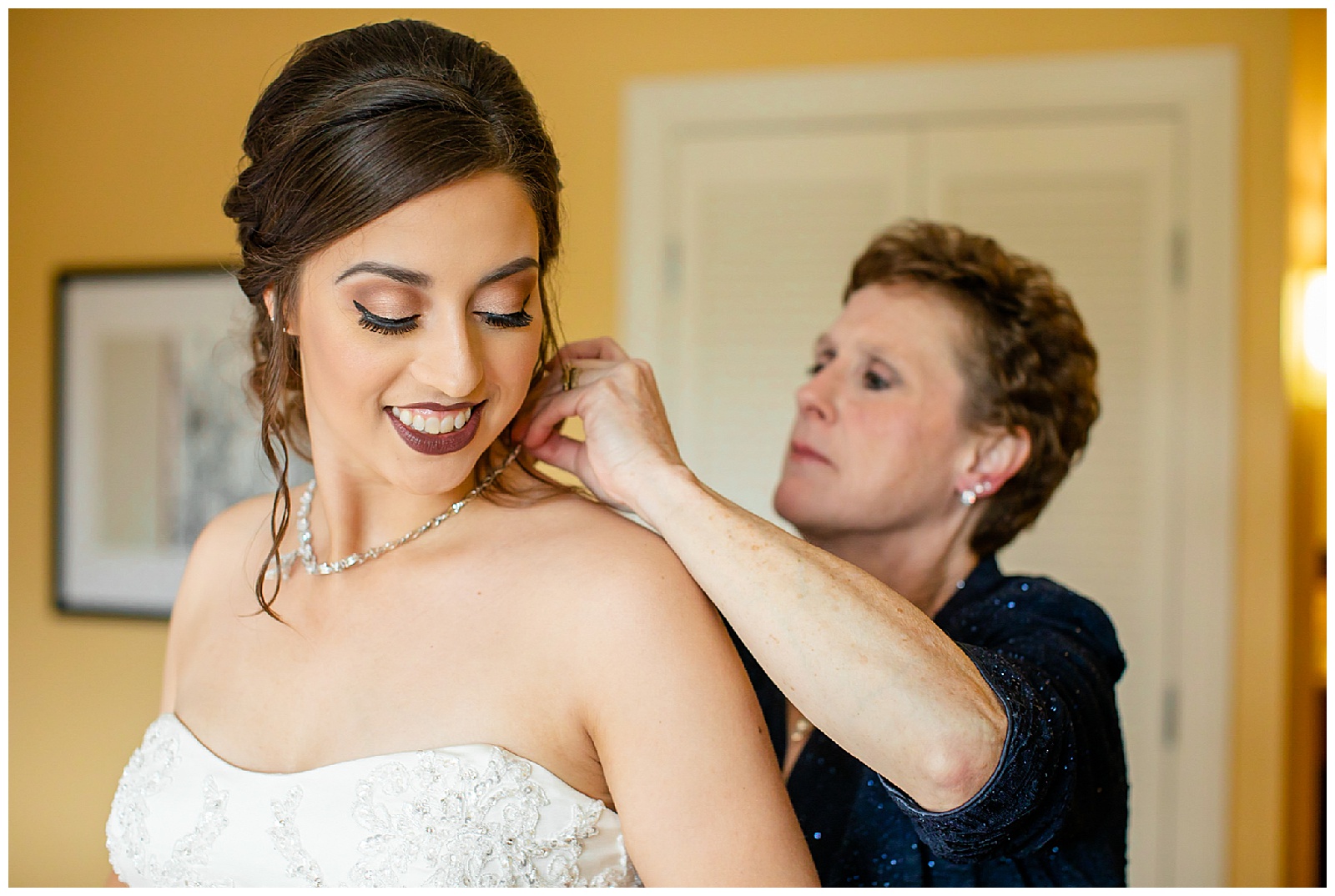 A mother helping her daughter get ready on the wedding day.