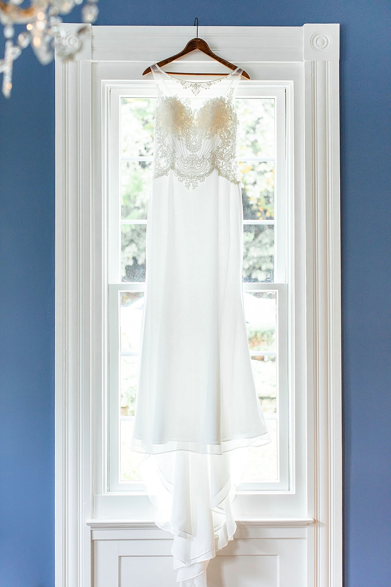 pittsburgh wedding photographer sleeveless wedding dress hanging on window